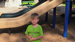 Pierce standing in front of a playground